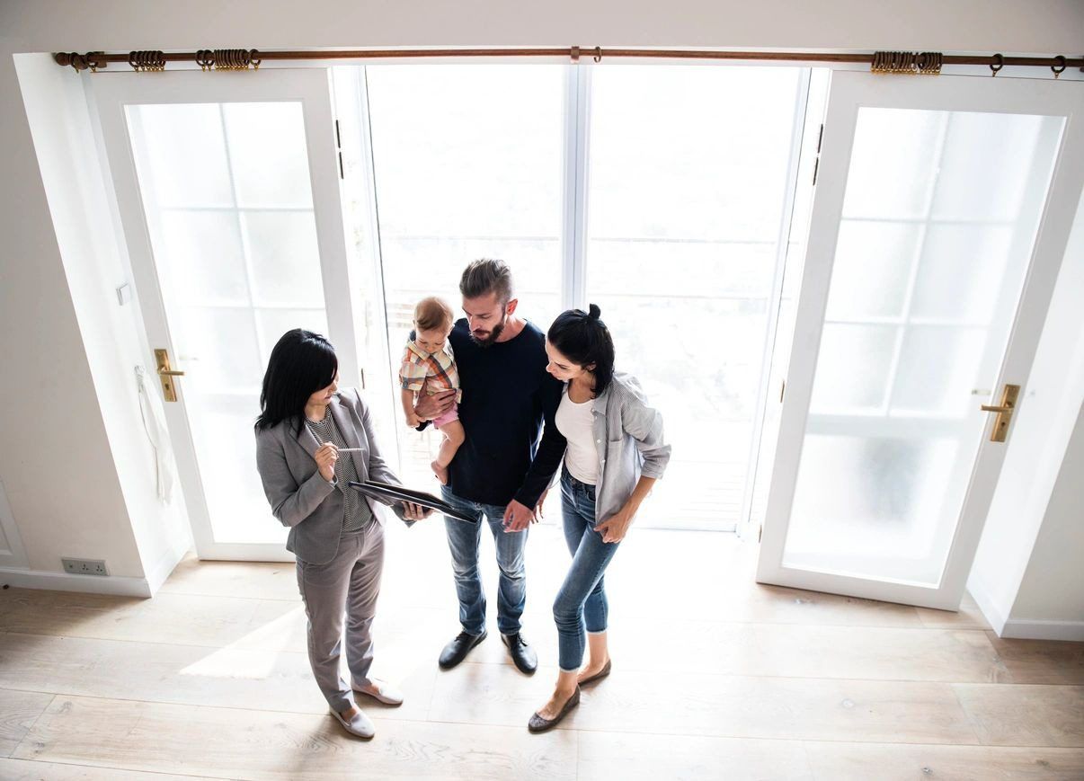 A group of people standing in front of a door.